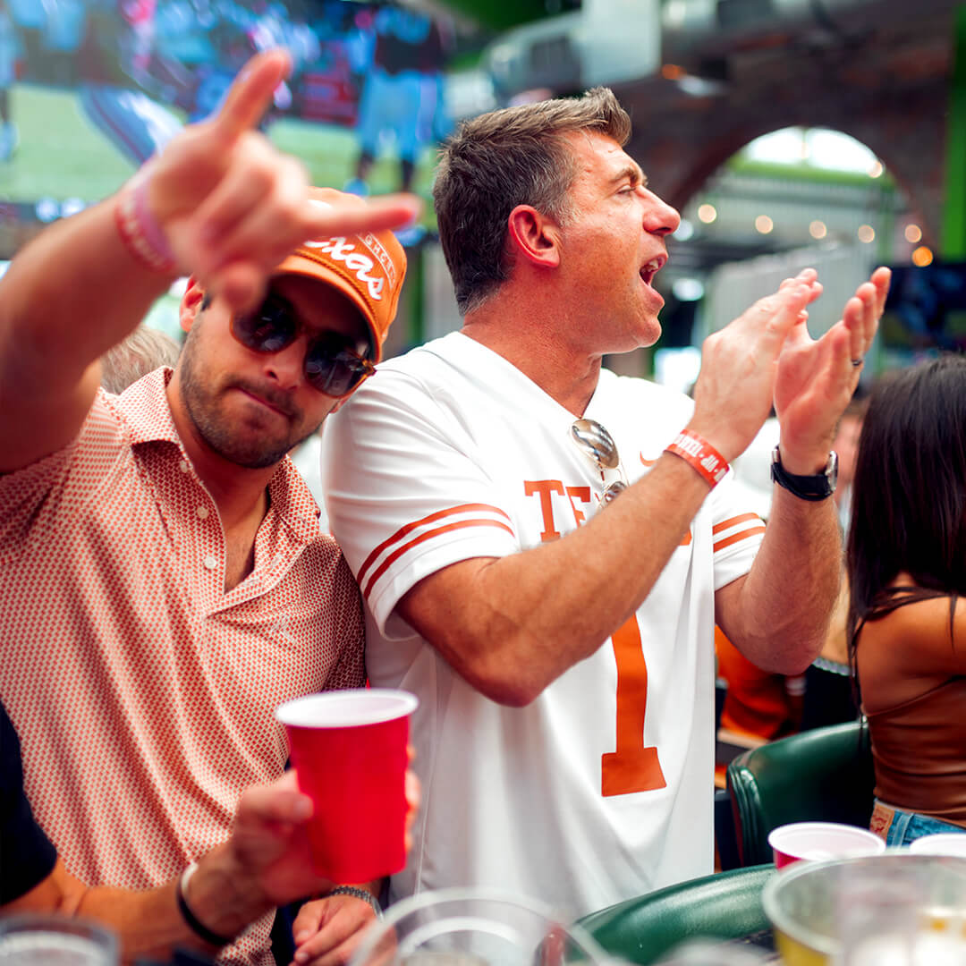 Two Texas Longhorns fans celebrating during Red River Rivalry weekend
